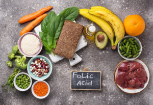 Picture of foods high in folic acid (folate) and a sign that says folic acid.