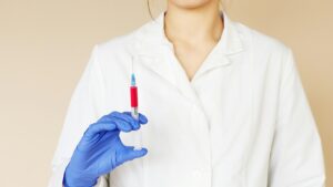 Doctor holding syringe for injection