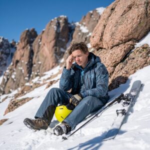 Skier resting after a long day at high altitude near Boulder showing winter fatigue symptoms