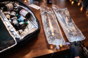 IV therapy preparation with medical equipment and nutrient solutions in a professional clinical setting.