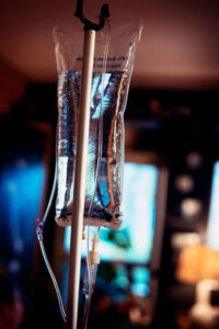 Close-up of IV fluid bag used for hydration therapy in a clinical setting.