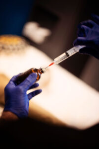 Peptide therapy injection preparation with syringe and vial in clinical setting