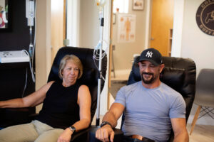 Adults receiving wellness therapy to support recovery, hydration, and healthy aging after 40